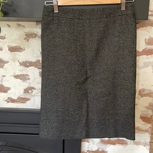 Ann Taylor skirt, lined, thin tweed feel with button detail in back.